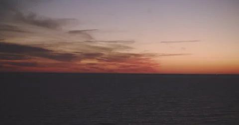 Pink sunset over a calm ocean Stock Footage 203589228