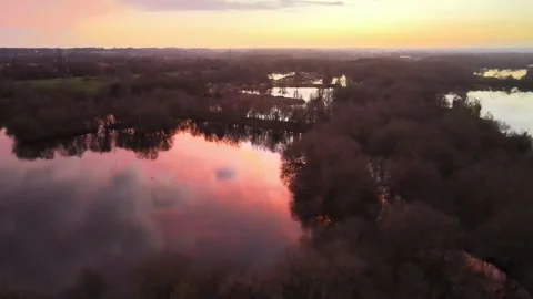 Pink sunset reflected on still winter lake Stock Footage 149280679