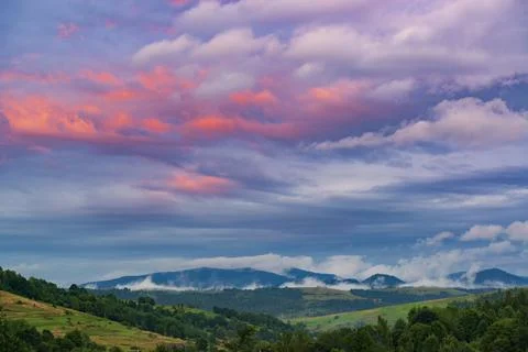 Pink sunset sky in the mountains. Photos