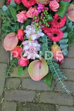 Pink sympathy bouquet on pavement Stock Photos