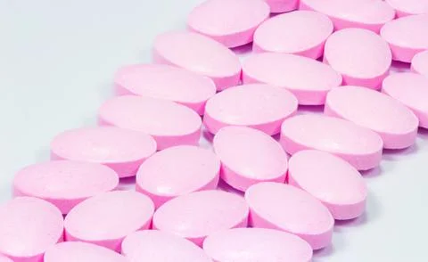 The pink tablets isolated on white background Stock Photos