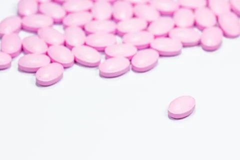The pink tablets isolated on white background Stock Photos
