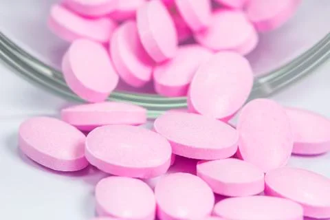 The pink tablets isolated on white background Stock Photos