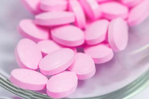 The pink tablets isolated on white background Stock Photos
