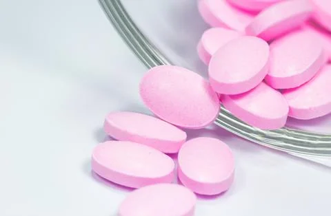 The pink tablets isolated on white background Stock Photos