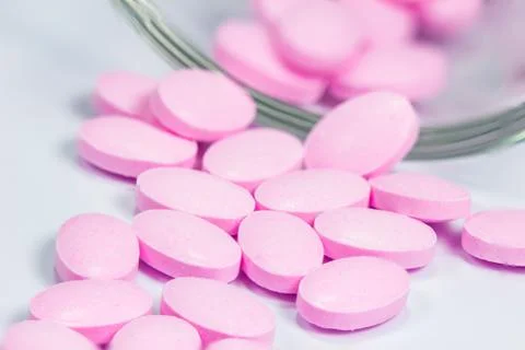 The pink tablets isolated on white background Stock Photos