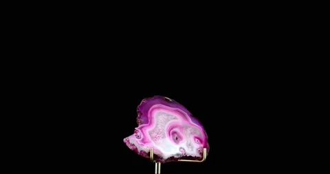 Pink tainted agate slice on support 360° rotation Stock Footage 237601148