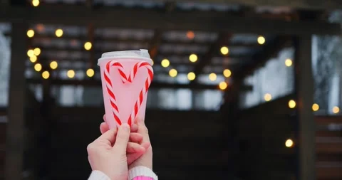 Pink takeout cup with candy cane heart raises waste awareness, since waste from Stock Footage 302390363