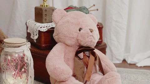 Pink teddy bear with festive candy canes. Christmas Holiday scene Stock Footage 255545959