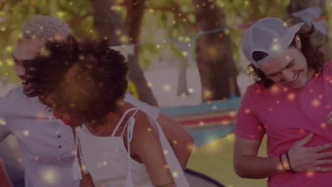 Pink tee man laughing from shoulder tap camera panning crew linking golden Stock Footage 333602444