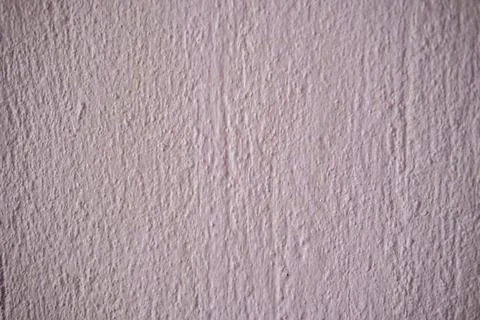 Pink textured wall background with rough stucco plaster surface and paint Stock Photos