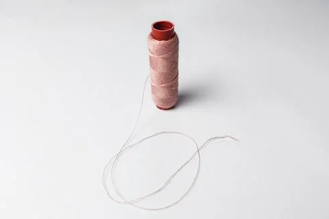 Pink thread that has been used on a white background Stock Photos