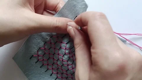 Pink Thread Stitched Through Black Sashiko Stitches on Blue Fabric. 스톡 동영상 340122874