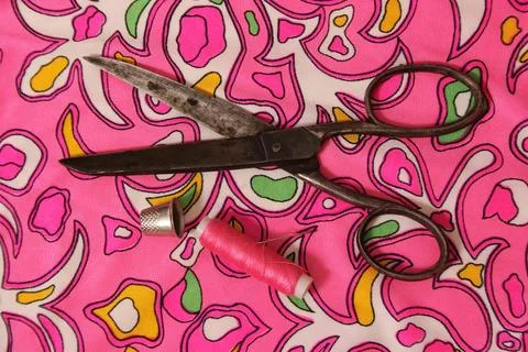 Pink Thread With Thimble and Scissors on Vintage Fabric Stock-Fotos