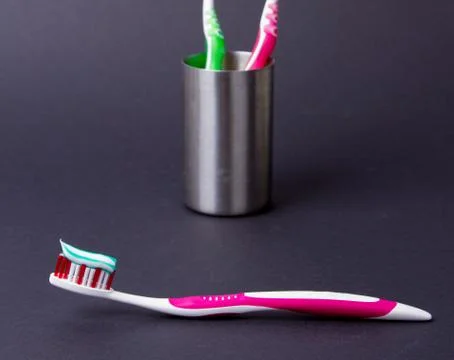 A pink toothbrush with toothpaste Stock Photos
