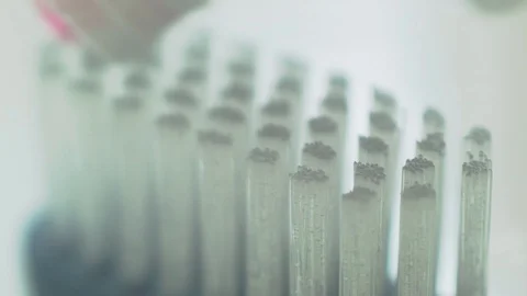 Pink toothpaste on toothbrush macro shot Stock Footage 129908672