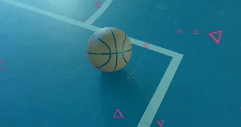Pink triangles drifting into view around basketball on blue court, highlighting Video stock 317591954