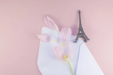 Pink tulip in envelope with eiffel tower miniature Stock Photos