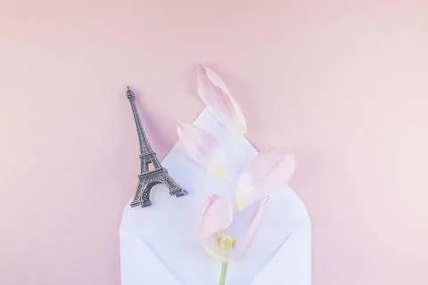 Pink tulip in envelope with eiffel tower miniature Pink tulip with petals ... Stock Photos