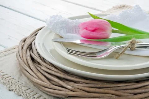 Pink tulip on rustic dinner setting Stock Photos