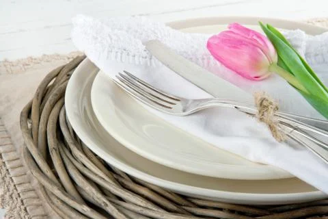 Pink tulip on rustic dinner setting Stock Photos
