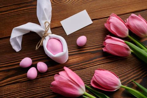 Pink tulips and easter egg on wooden background Stock Photos
