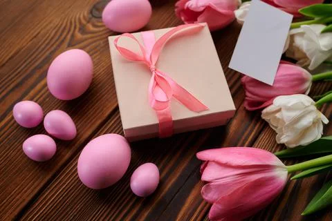 Pink tulips, easter eggs and gift box Stock Photos