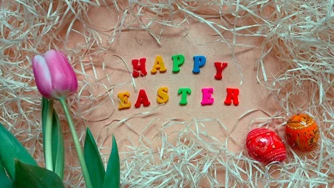 Pink tulips, words "Happy Easter" and Easter eggs Stock Footage 104084843