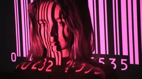 Pink UPC code projected onto attractive young womans face. Stock Footage 77582524