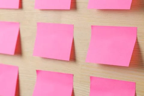 Pink various notes or sticky post-it on wooden office table background .mocku Stock Photos