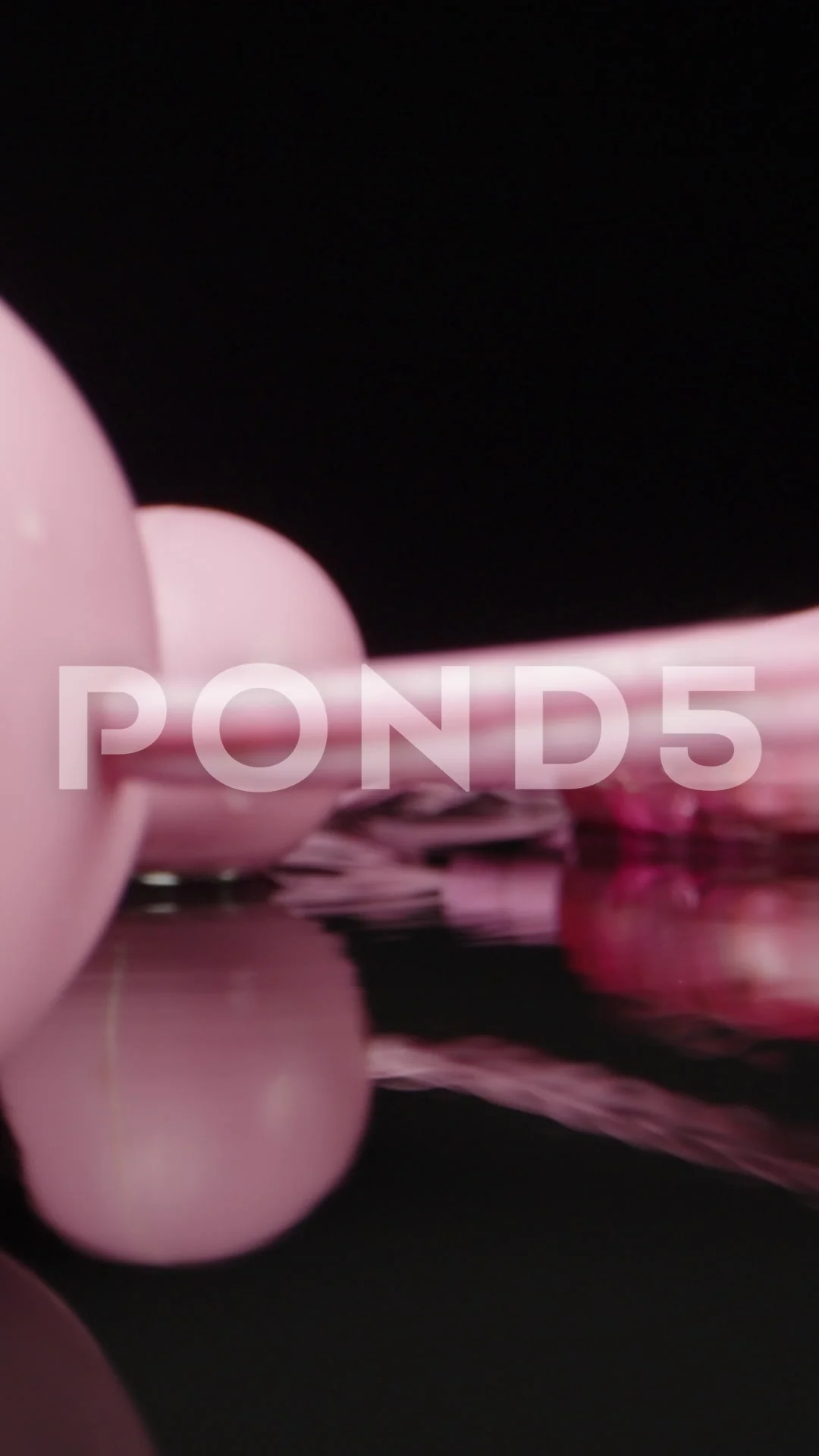 Pink vibrating balls. Sex toy, splashing water. Dolly slider extreme  close-up. L