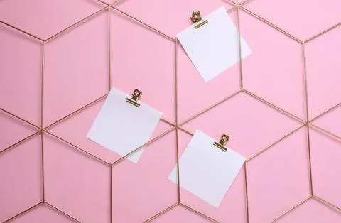 Pink wall with hexagon pattern and blank notes clips Stock Photos