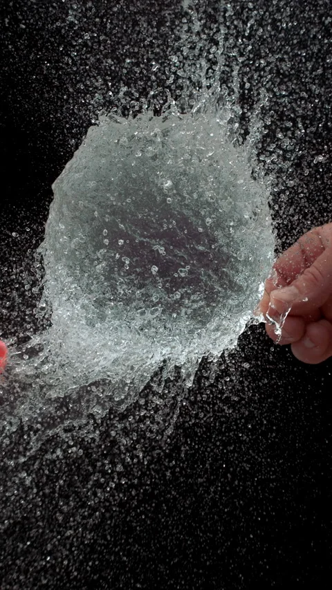 Pink Water Balloon Exploding From Needle Prick In Ultra Slow Motion Video stock 314303065