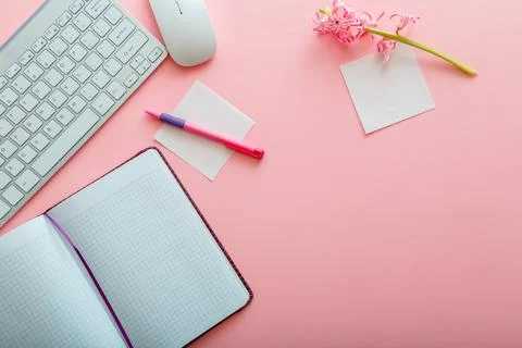 Pink work desk. Work space Office table with computer keyboard and mouse notepad Stock Photos