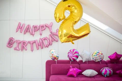 Pink, yellow and white balloons on a light background. Inscription Happy Stock Photos