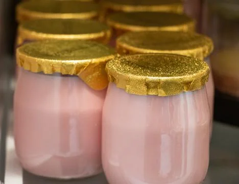 Pink yoghurt with golden seal. Stock Photos