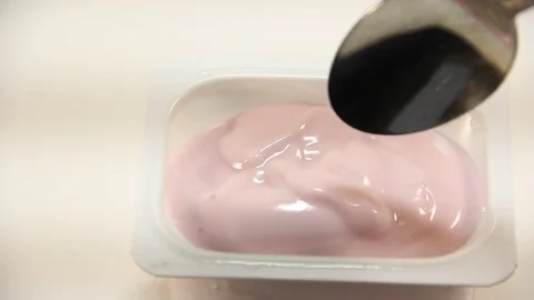 Pink yogurt spoon Stock Footage 84138755