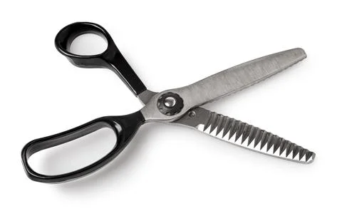 Pinking shears cutting zigzag edge on fabric tool Stock Photos