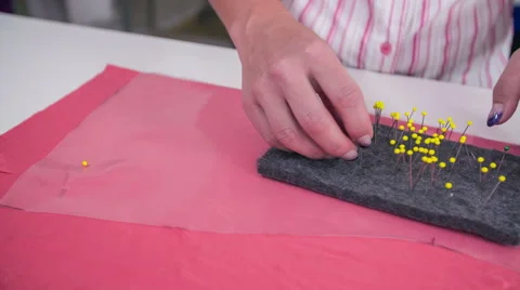 Pinning plastic foil on to pink textile Stock Footage 41013405