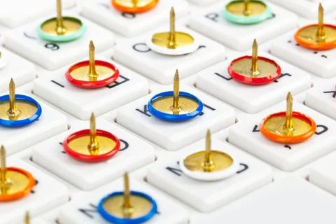 Pins on computer keyboard Pins on computer keyboard - concept background C... Stock Photos