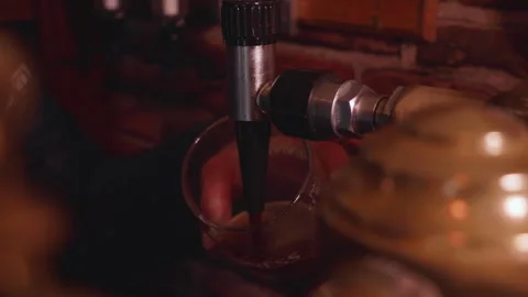 A pint of Guinness being pulled poured into a glass in an Irish pub. Stock Footage 302886013