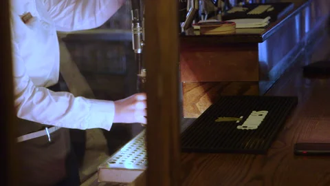 A pint of Guinness served to a customer at a bar Stock Footage 235437232