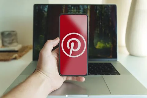 Pinterest application logo in front of laptop. High quality photo Stock Photos