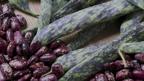 Pinto beans and green beans on wooden table panning handheld camera, 4K Stock Footage 341708532