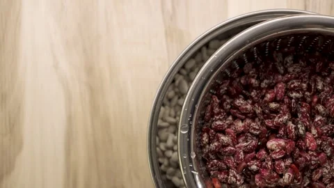 Pinto beans in colander reveal empty wooden table Copy Space 4k 10bit Stock Footage 333290016