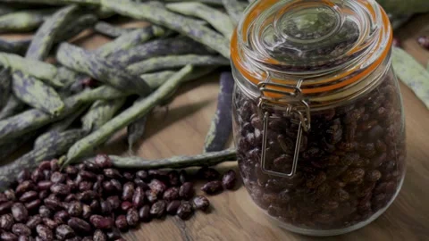 Pinto beans jar on wooden table with green beans panning handheld camera, 4K Stock Footage 341638500