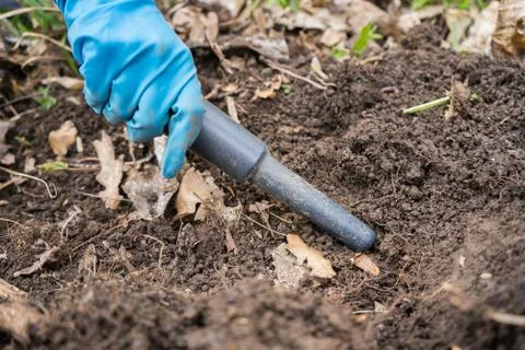 Pintpoint metal detector in hand. Pintpointer at work. Stock Photos