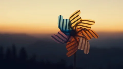 Pinwheel colored plastic rotate, windmill with wind background of mountain peaks Stock Footage 123385397