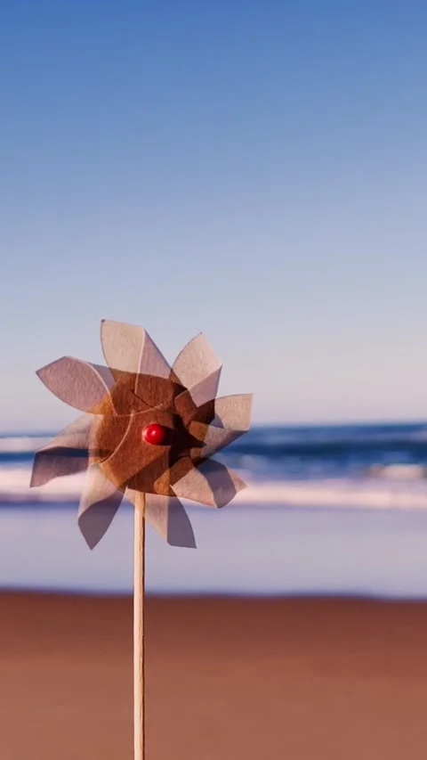 Pinwheel or windmill on ocean blurred background Stock Footage 243789714