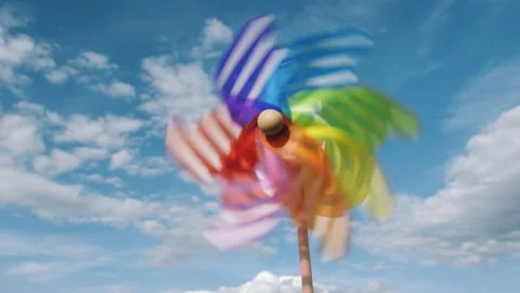 Pinwheel rotating colored spinning plastic with blowing wind against blue sky Stock Footage 132125852